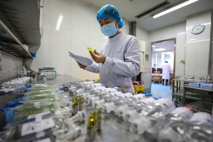 A nurse prepares medicine for coronavirus patients