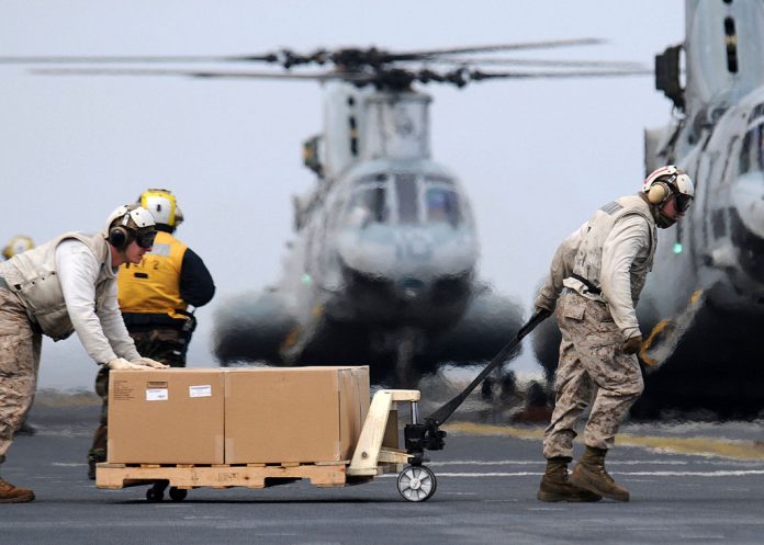 Marines load humanitarian supplies onto CH 46E helicopters in support of Operation Tomodachi0A