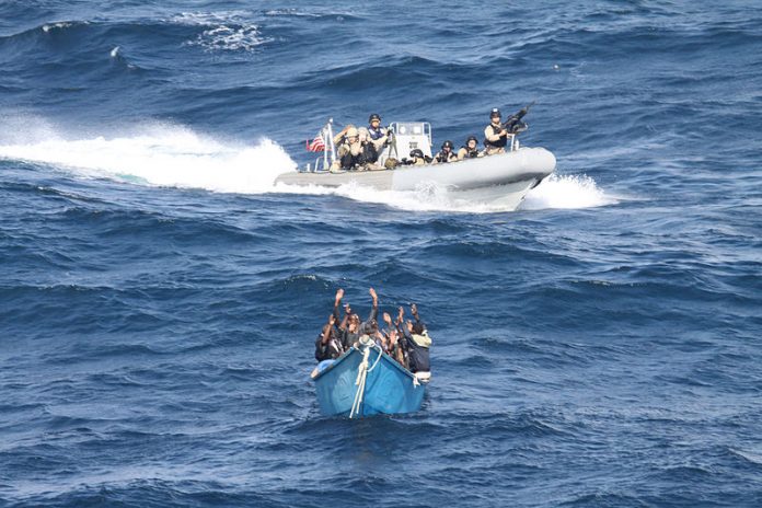 800px US Navy 111219 N ZZ999 070 A visit board search and seizure team from the guided missile destroyer USS Pinckney DDG 91 approaches a suspected p